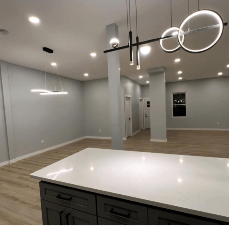 Open-concept kitchen renovation in Park Slope Brooklyn — white shaker cabinets and marble countertops by Dream Build Construction